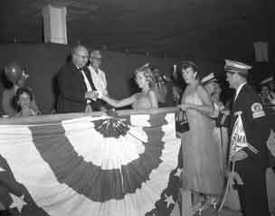 Pretty girl shaking hand of councilman.