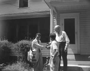 Todd handing paper to older man.