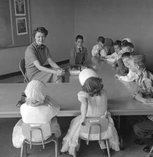 Teacher and students around a table