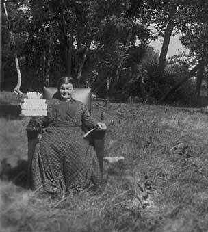 Seated in a pasture.