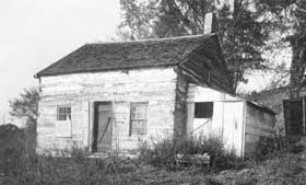 Small wooden structure with leanto addition.