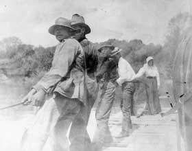 Group of people tugging on a rope.